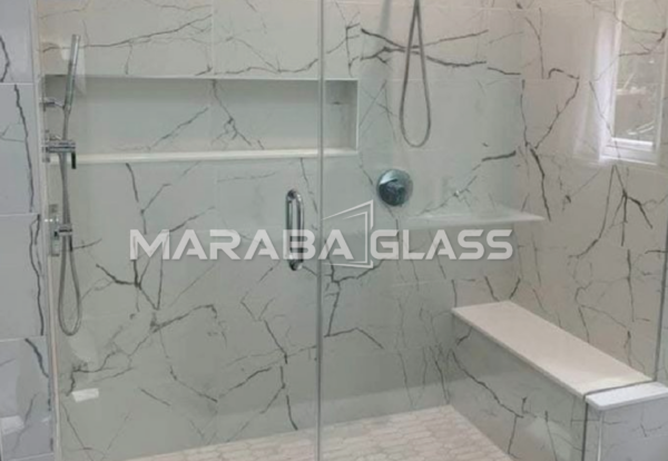 Modern frameless shower cubicle with 8mm tempered safety glass installed by Maraba Glass & Aluminum Systems Ltd.