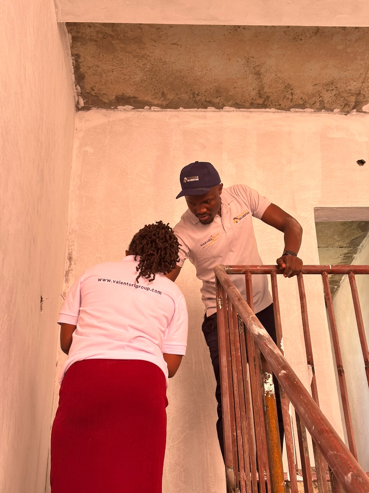 Professional consultant measuring a commercial glass installation during an on-site consultation.